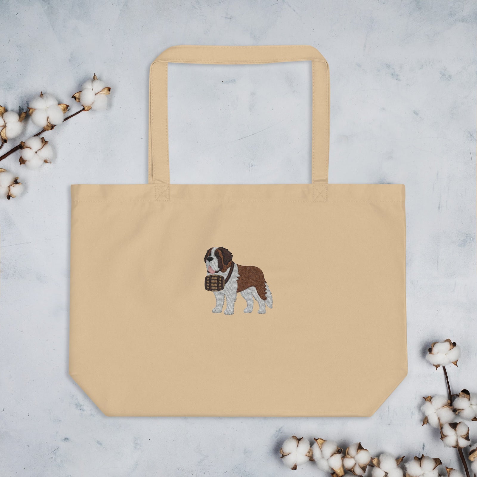 Large beige organic tote bag embroidered with a detailed Saint Bernard with a barrel around its neck by Lucy and Norman.