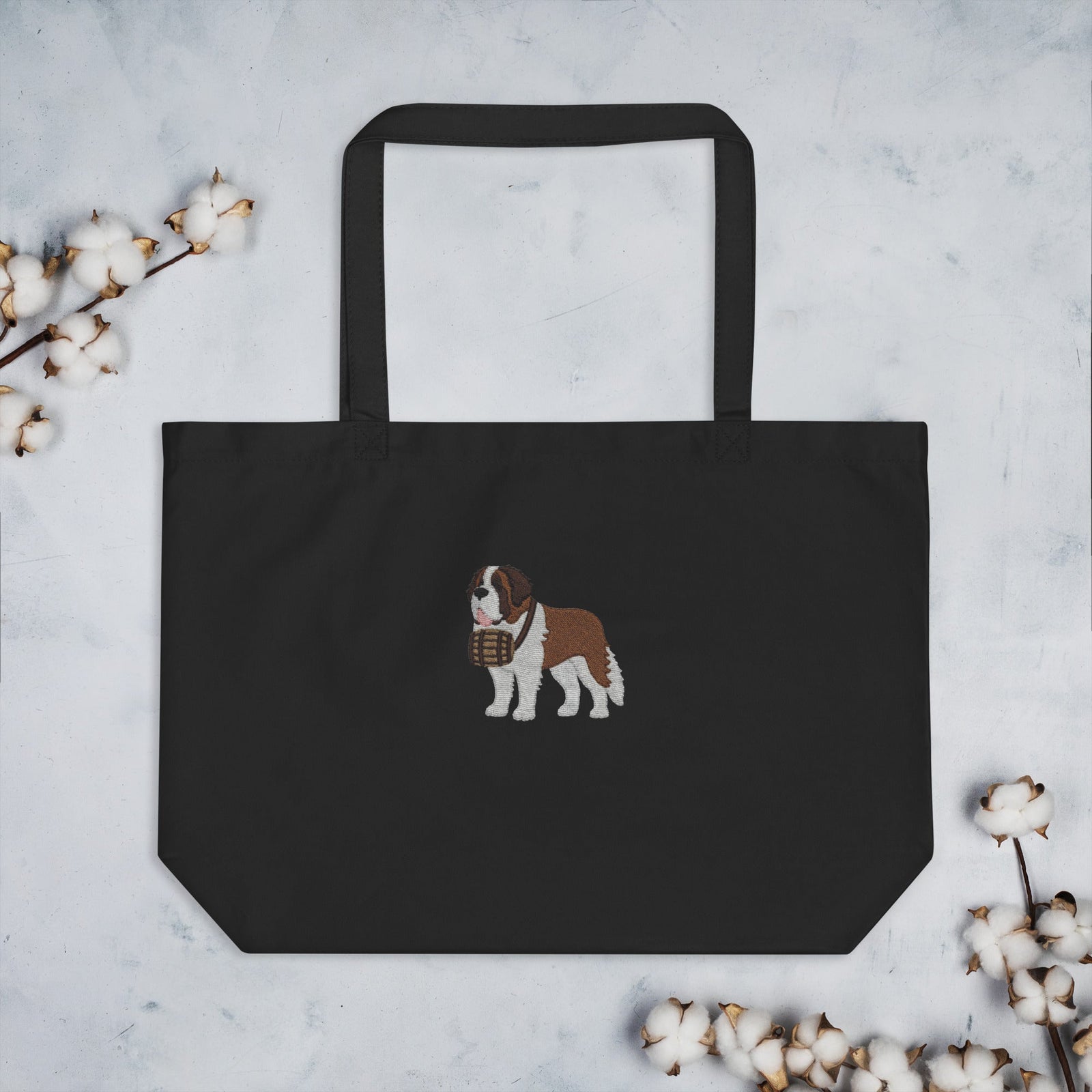 Large black organic tote bag embroidered with a detailed Saint Bernard with a barrel around its neck by Lucy and Norman.