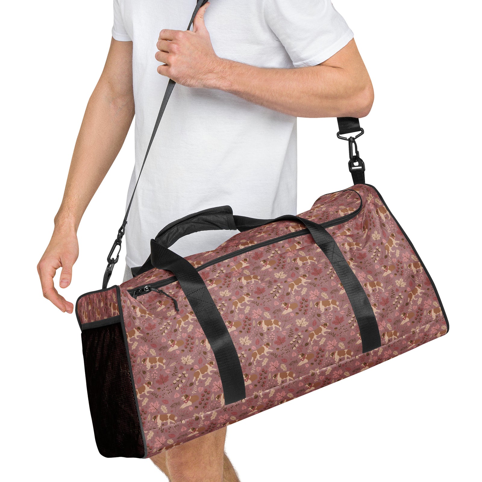 Rosy Fall Saint Bernard floral duffle bag in warm pink, brown, and autumn leaf tones with black padded shoulder strap, handles, zip compartment, and mesh side pocket.