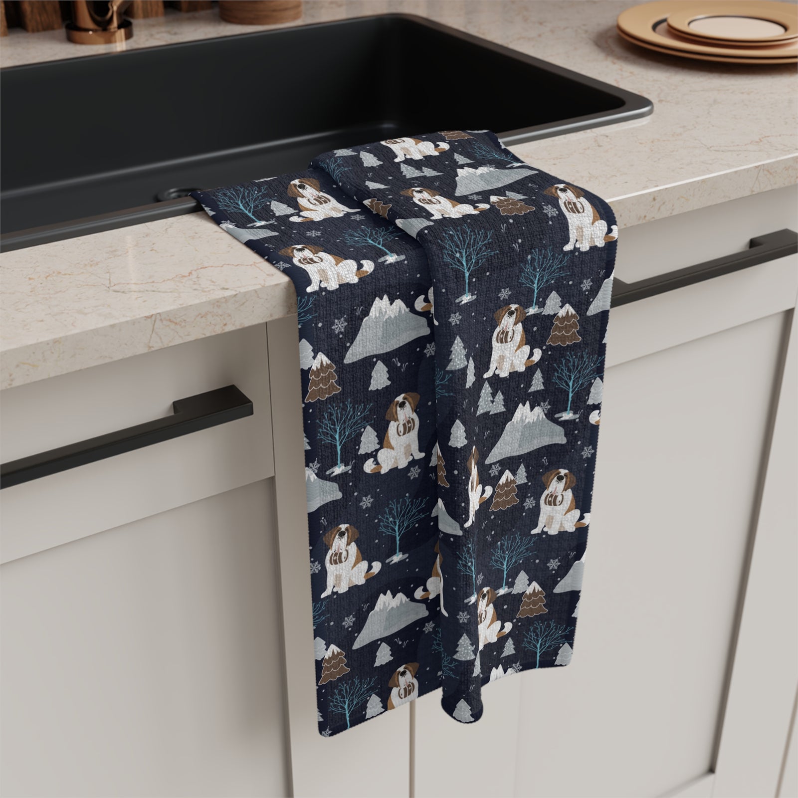 Alpine Chill Saint Bernard microfiber tea towel with a navy print of Saint Bernards with rescue barrels among frosty trees and snowy mountains.