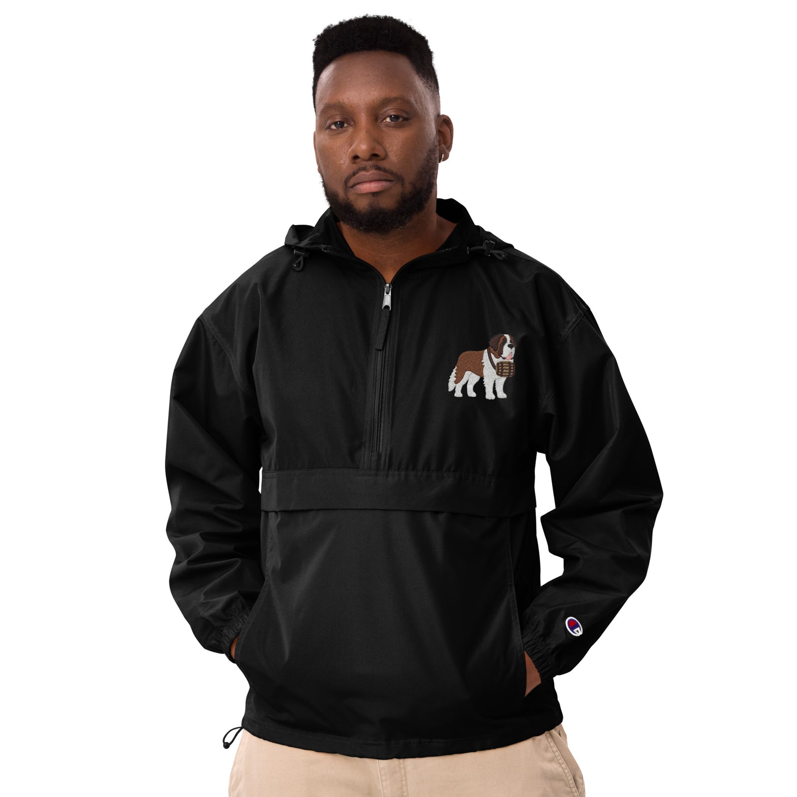 Black Champion packable windbreaker with chest embroidered Saint Bernard and barrel, half zip pullover with hood, kangaroo pocket, and zip pouch.
