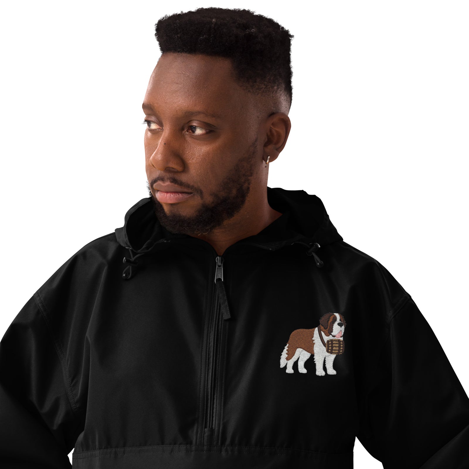 Black Champion packable windbreaker with chest embroidered Saint Bernard and barrel, half zip pullover with hood, kangaroo pocket, and zip pouch.