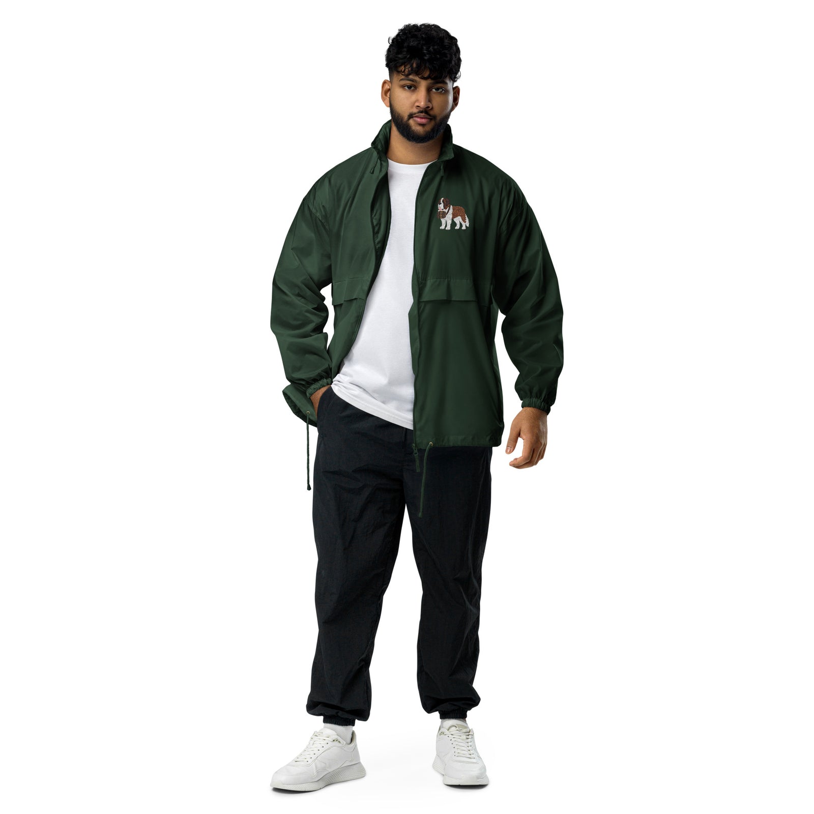 Lightweight, packable forest green windbreaker with chest embroidered Saint Bernard and barrel, adjustable hood, elastic cuffs, and zip pockets.