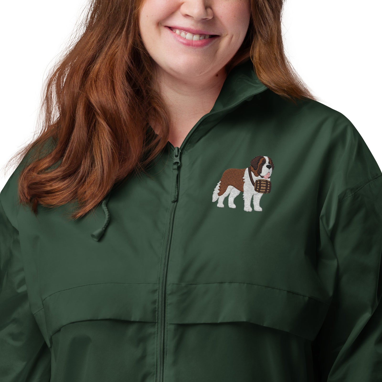 Lightweight, packable forest green windbreaker with chest embroidered Saint Bernard and barrel, adjustable hood, elastic cuffs, and zip pockets.