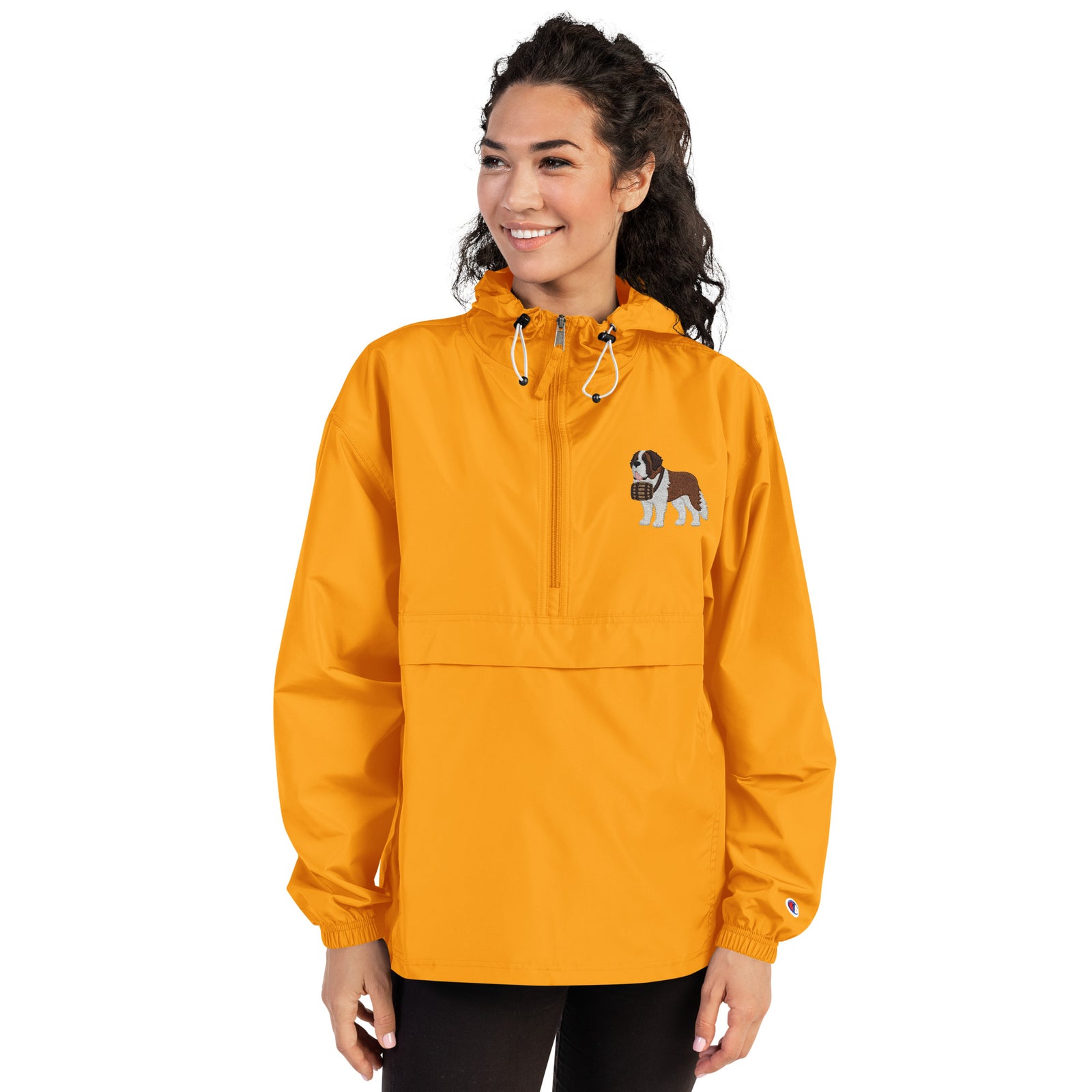 Gold Champion packable windbreaker with chest embroidered Saint Bernard and barrel, half zip pullover with hood, kangaroo pocket, and zip pouch.