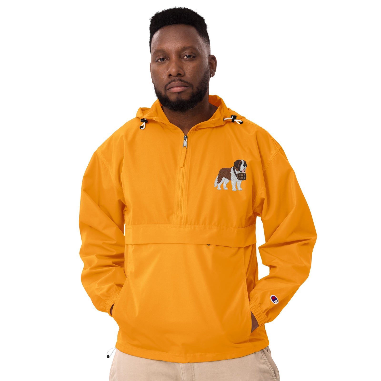 Gold Champion packable windbreaker with chest embroidered Saint Bernard and barrel, half zip pullover with hood, kangaroo pocket, and zip pouch.