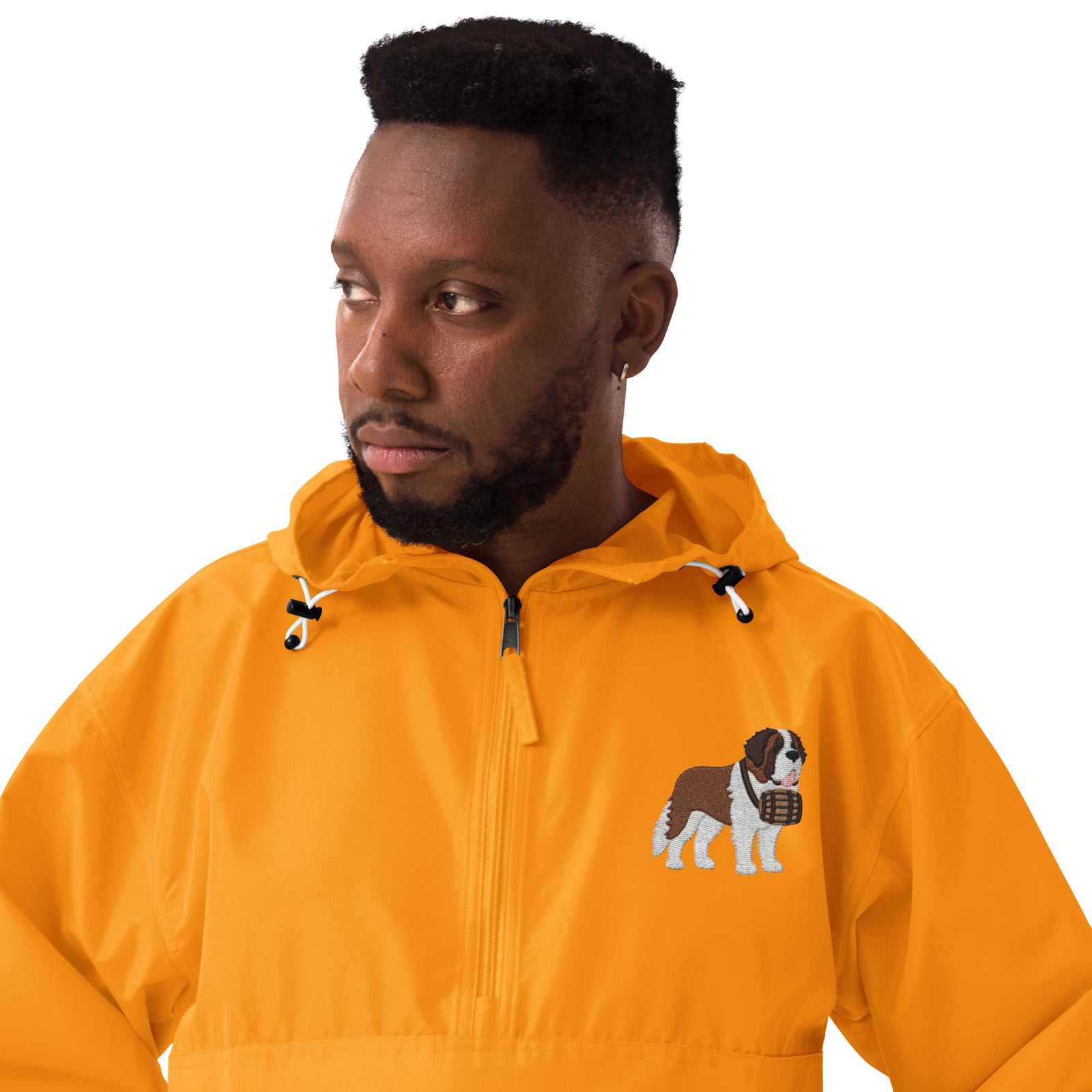 Gold Champion packable windbreaker with chest embroidered Saint Bernard and barrel, half zip pullover with hood, kangaroo pocket, and zip pouch.