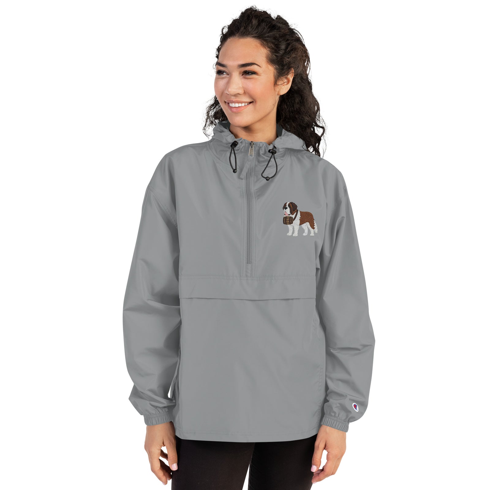 Light gray Champion packable windbreaker with chest embroidered Saint Bernard and barrel, half zip pullover with hood, kangaroo pocket, and zip pouch.