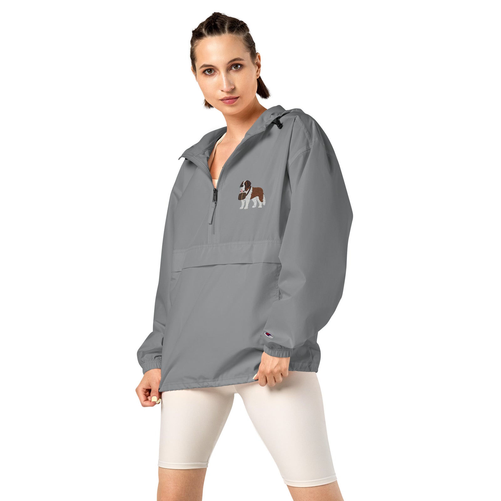 Light gray Champion packable windbreaker with chest embroidered Saint Bernard and barrel, half zip pullover with hood, kangaroo pocket, and zip pouch.