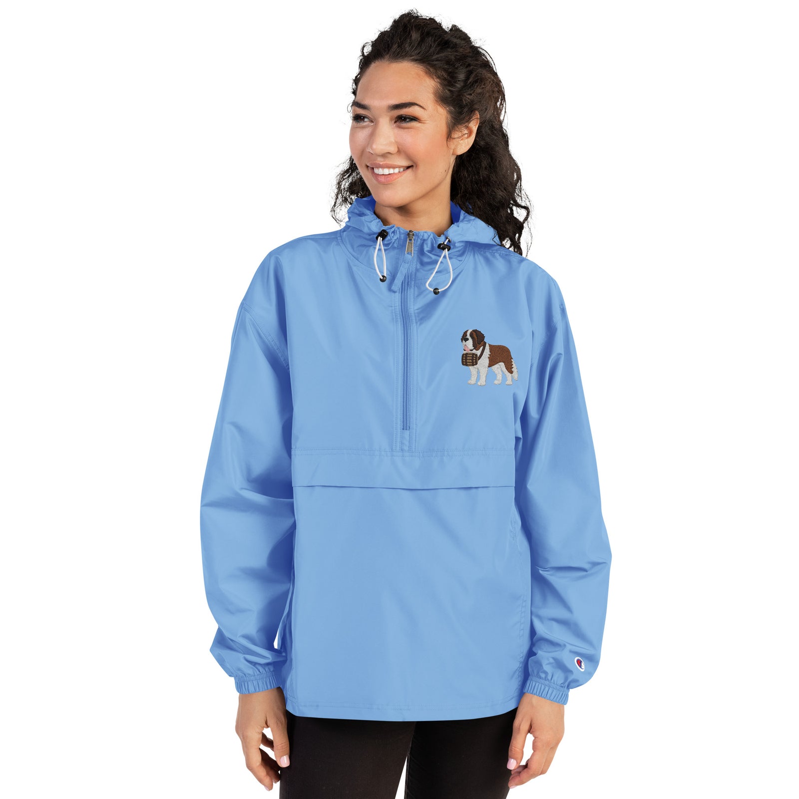 Light blue Champion packable windbreaker with chest embroidered Saint Bernard and barrel, half zip pullover with hood, kangaroo pocket, and zip pouch.