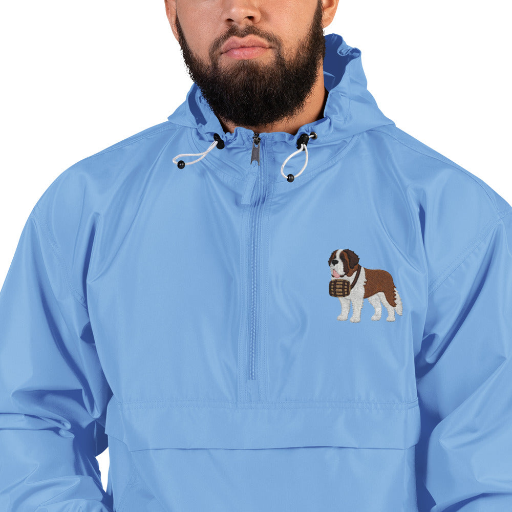 Light blue Champion packable windbreaker with chest embroidered Saint Bernard and barrel, half zip pullover with hood, kangaroo pocket, and zip pouch.