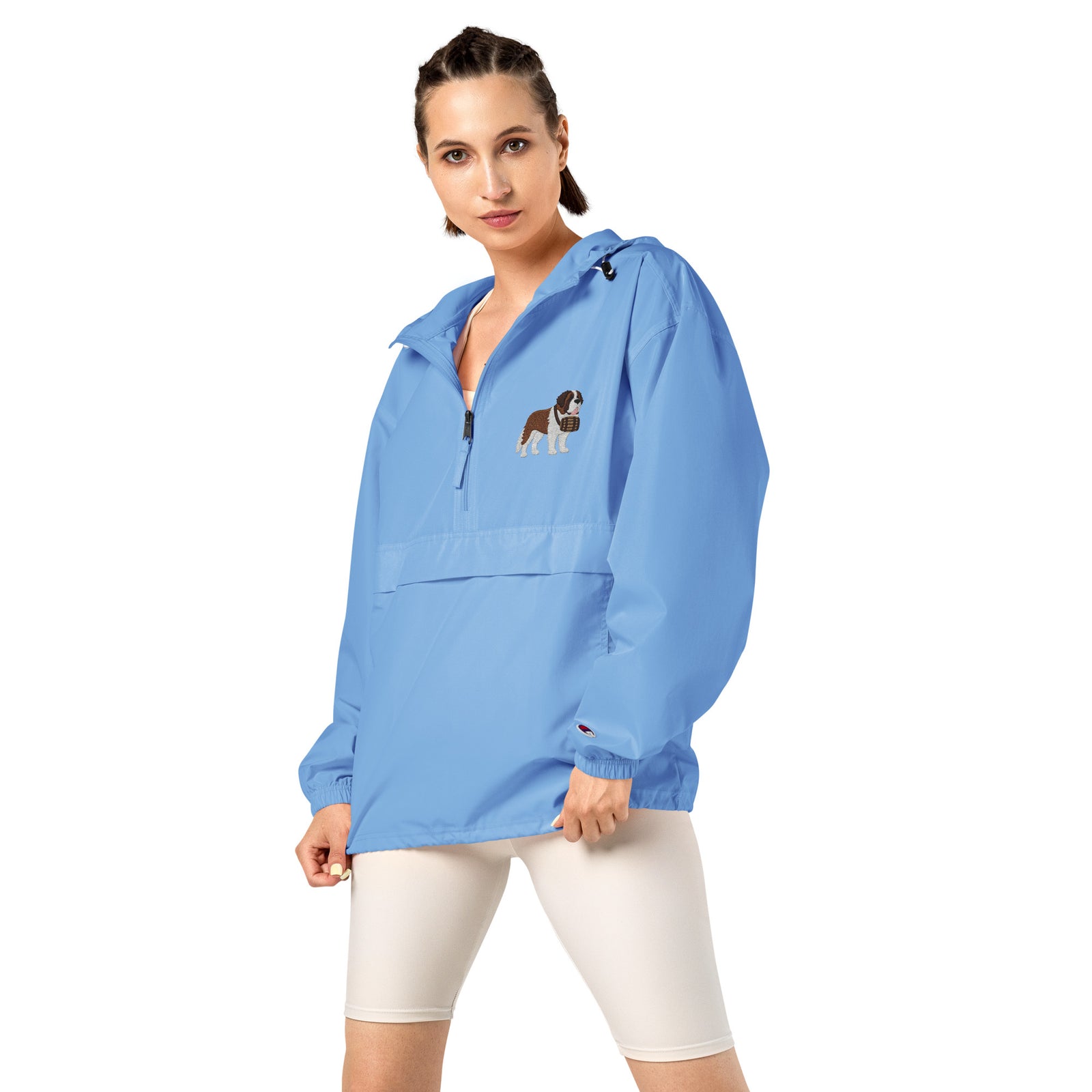 Light blue Champion packable windbreaker with chest embroidered Saint Bernard and barrel, half zip pullover with hood, kangaroo pocket, and zip pouch.