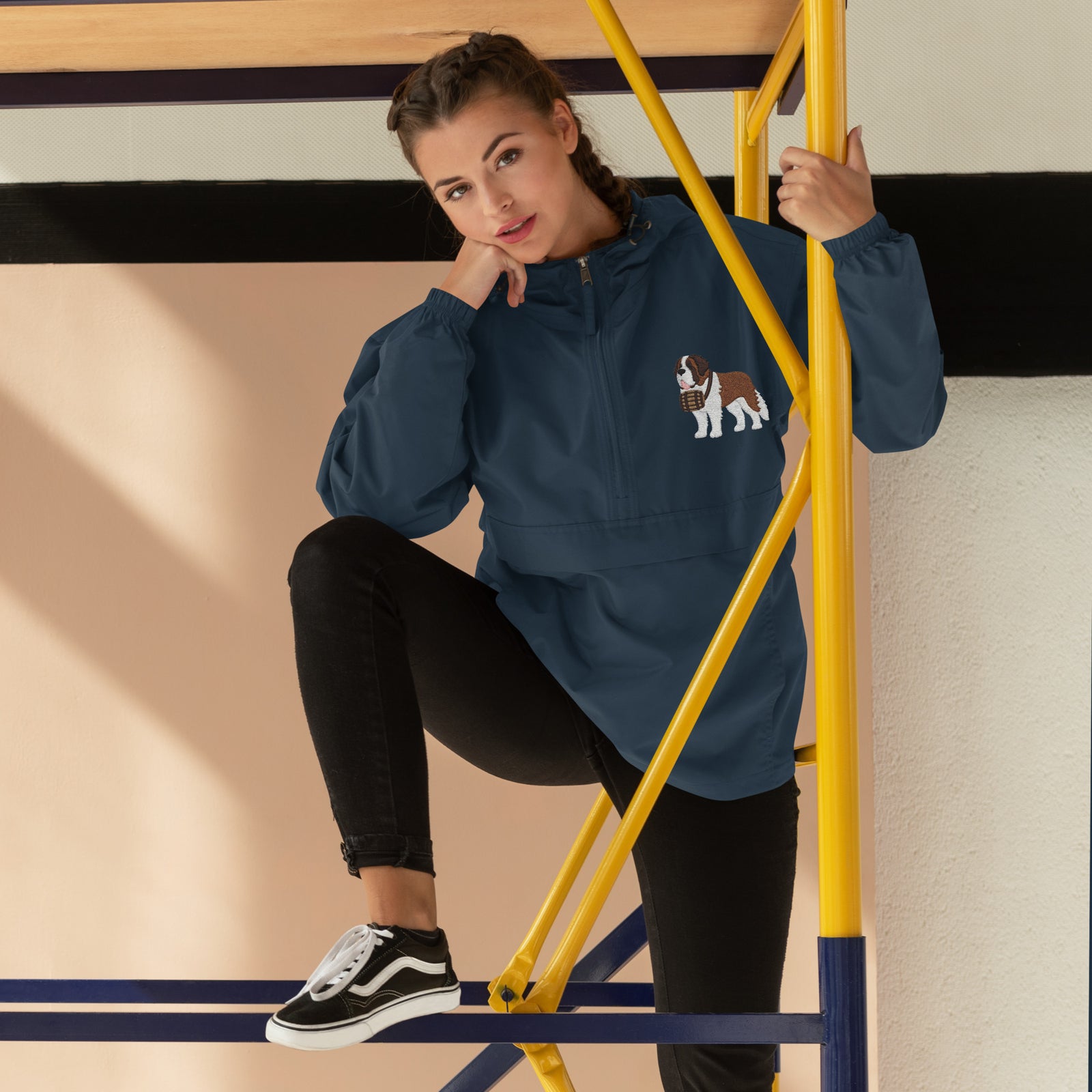 Navy blue Champion packable windbreaker with chest embroidered Saint Bernard and barrel, half zip pullover with hood, kangaroo pocket, and zip pouch.