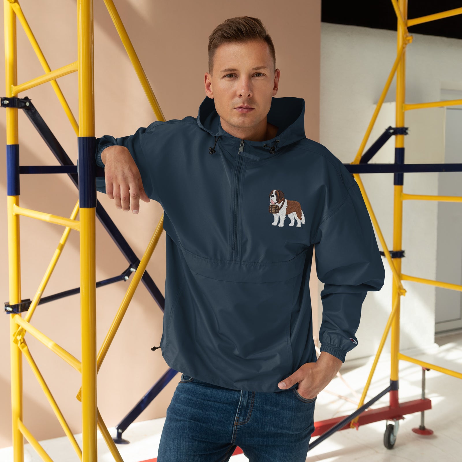Navy blue Champion packable windbreaker with chest embroidered Saint Bernard and barrel, half zip pullover with hood, kangaroo pocket, and zip pouch.