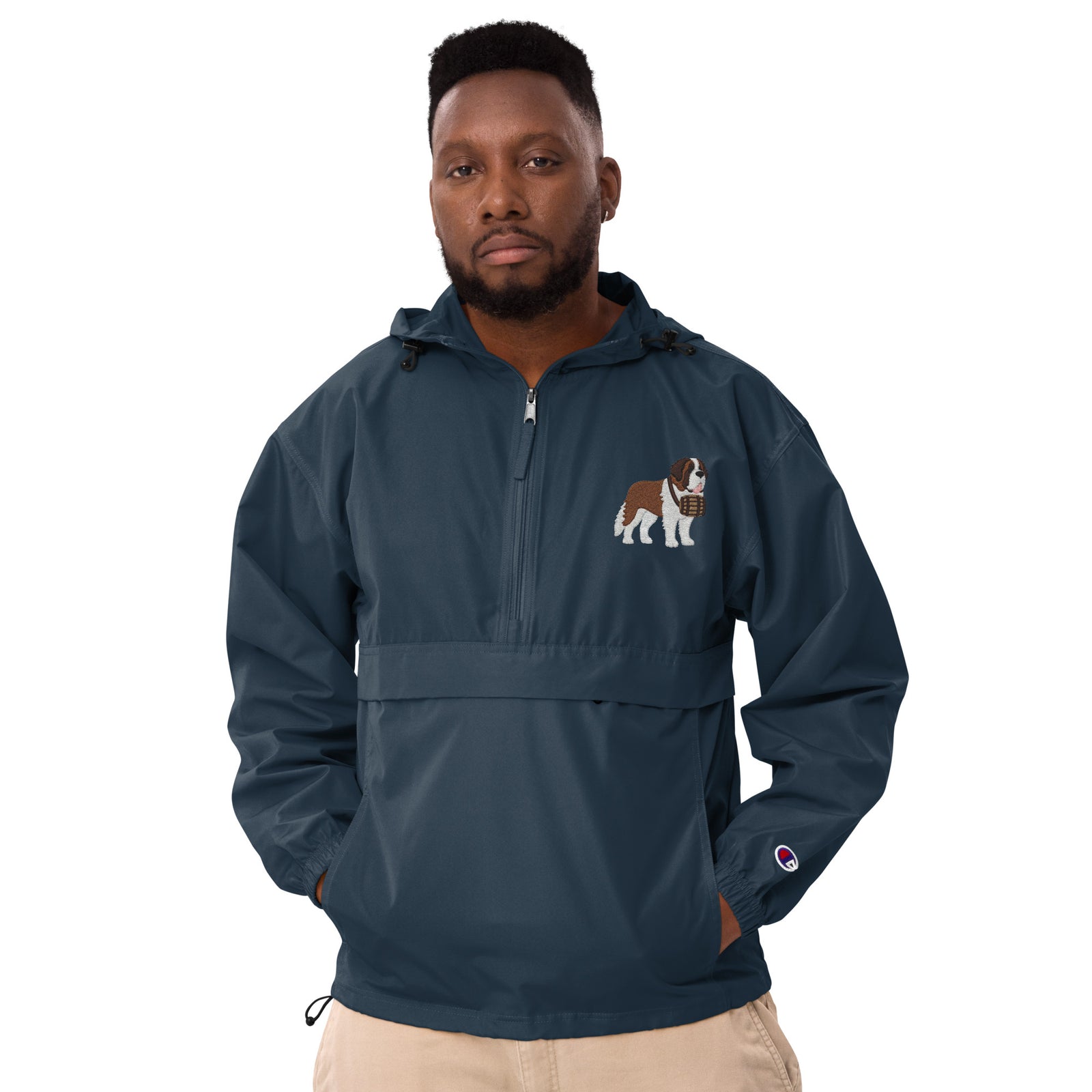 Navy blue Champion packable windbreaker with chest embroidered Saint Bernard and barrel, half zip pullover with hood, kangaroo pocket, and zip pouch.