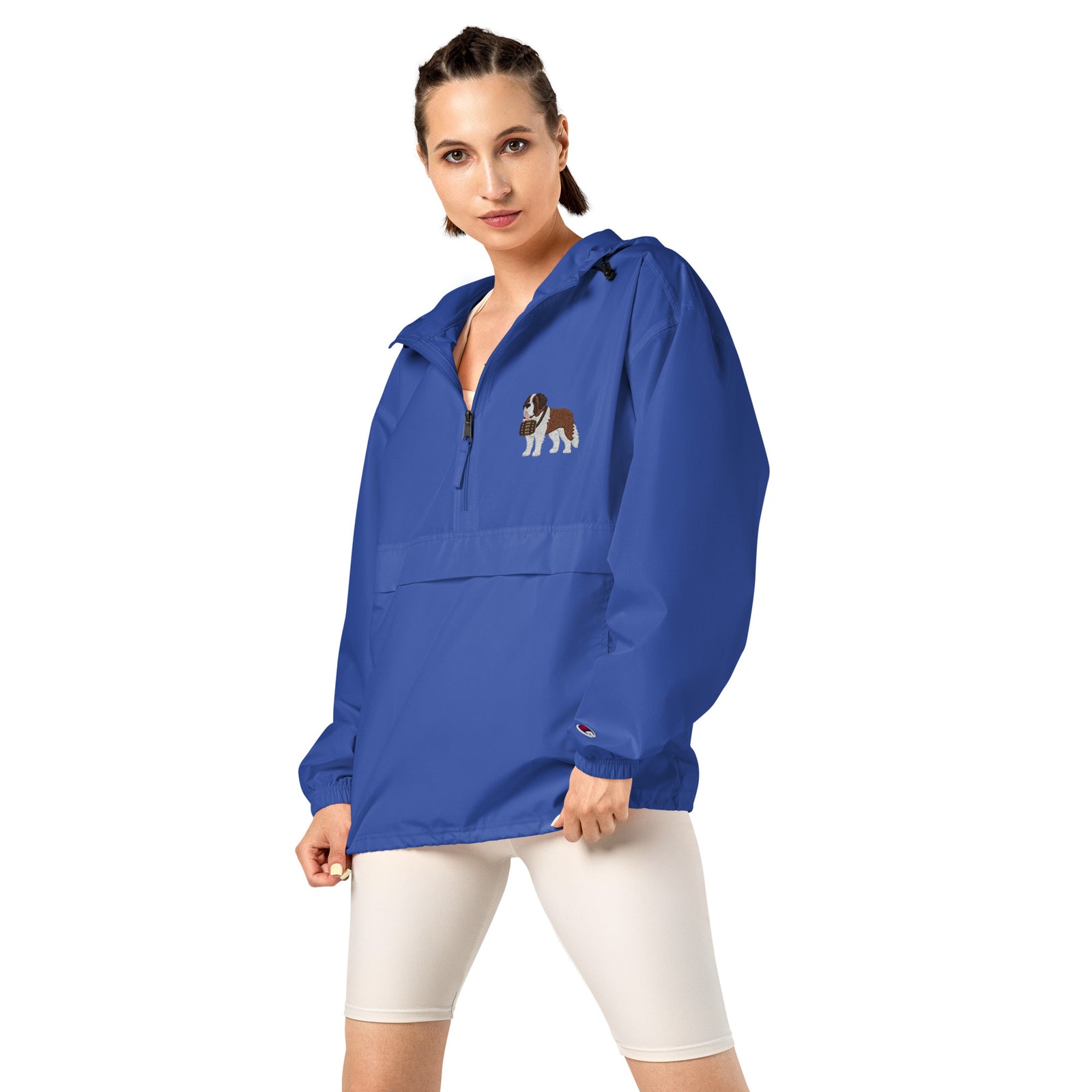 Royal blue Champion packable windbreaker with chest embroidered Saint Bernard and barrel, half zip pullover with hood, kangaroo pocket, and zip pouch.
