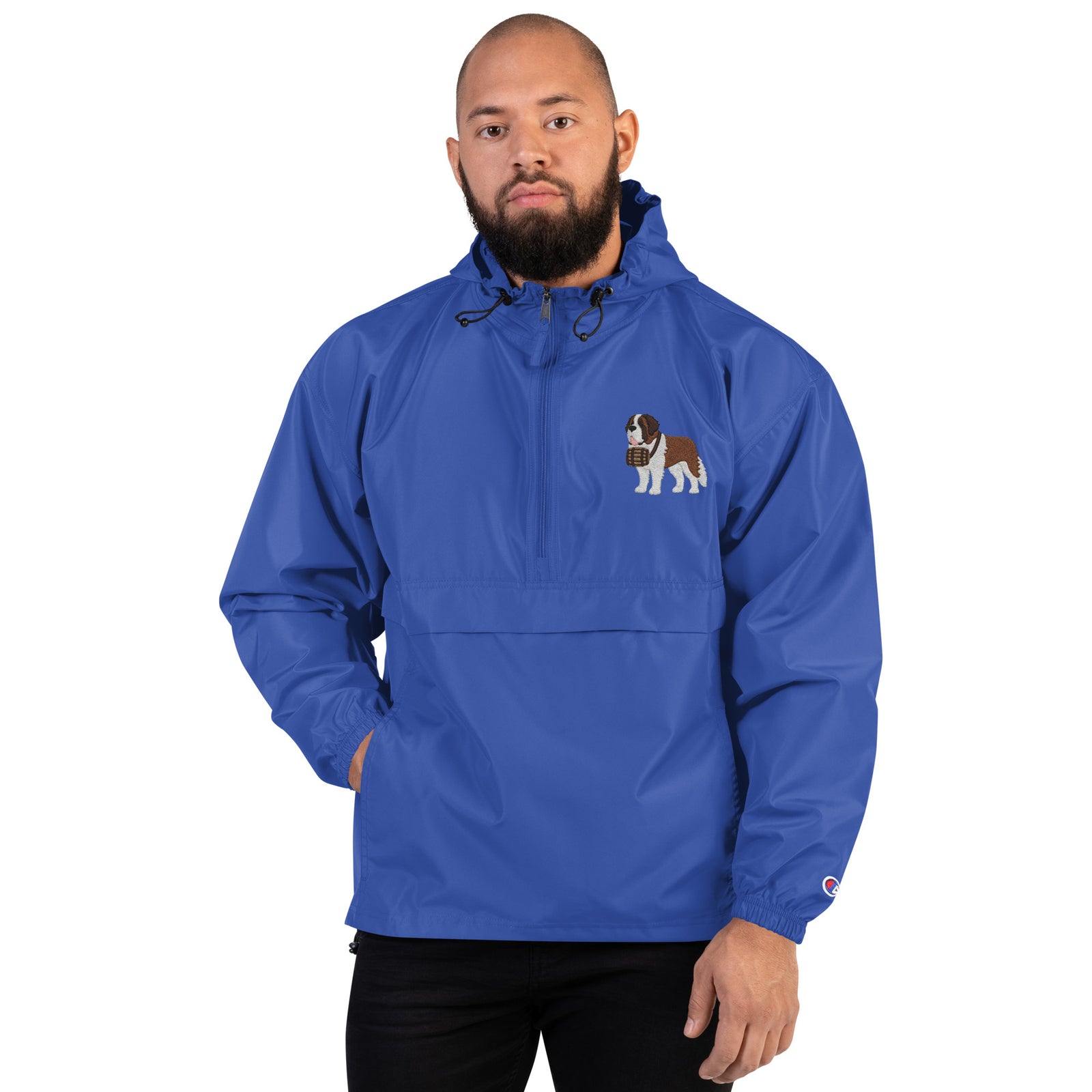 Royal blue Champion packable windbreaker with chest embroidered Saint Bernard and barrel, half zip pullover with hood, kangaroo pocket, and zip pouch.