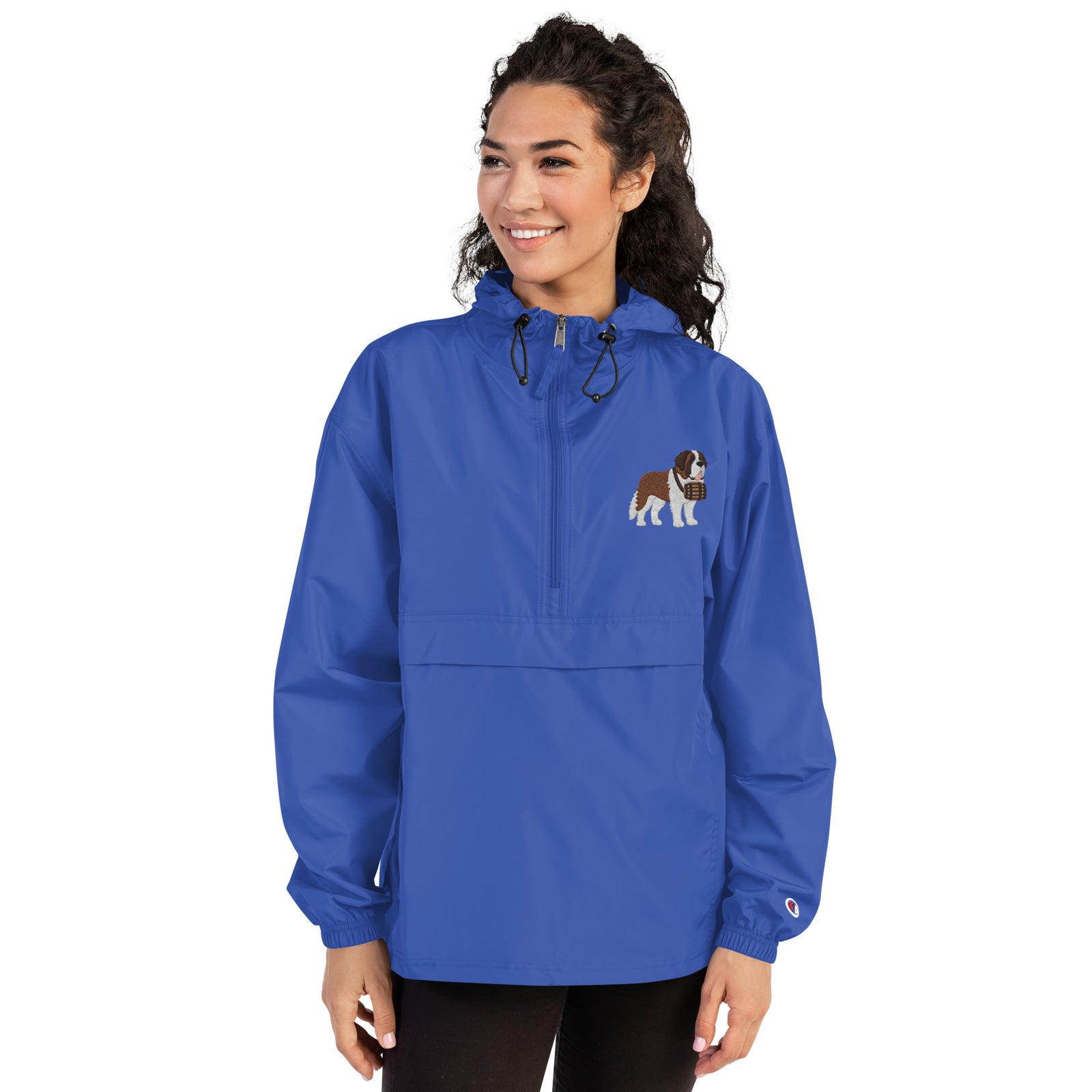Royal blue Champion packable windbreaker with chest embroidered Saint Bernard and barrel, half zip pullover with hood, kangaroo pocket, and zip pouch.