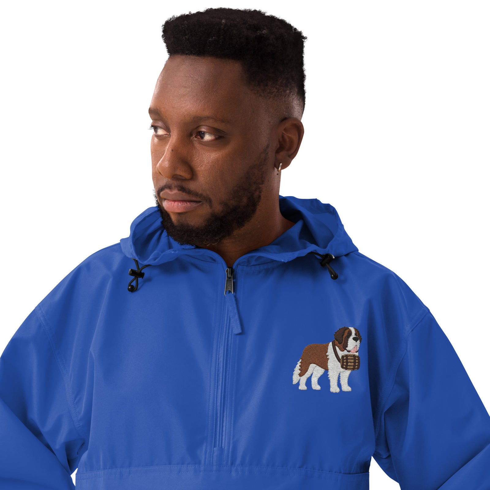 Royal blue Champion packable windbreaker with chest embroidered Saint Bernard and barrel, half zip pullover with hood, kangaroo pocket, and zip pouch.