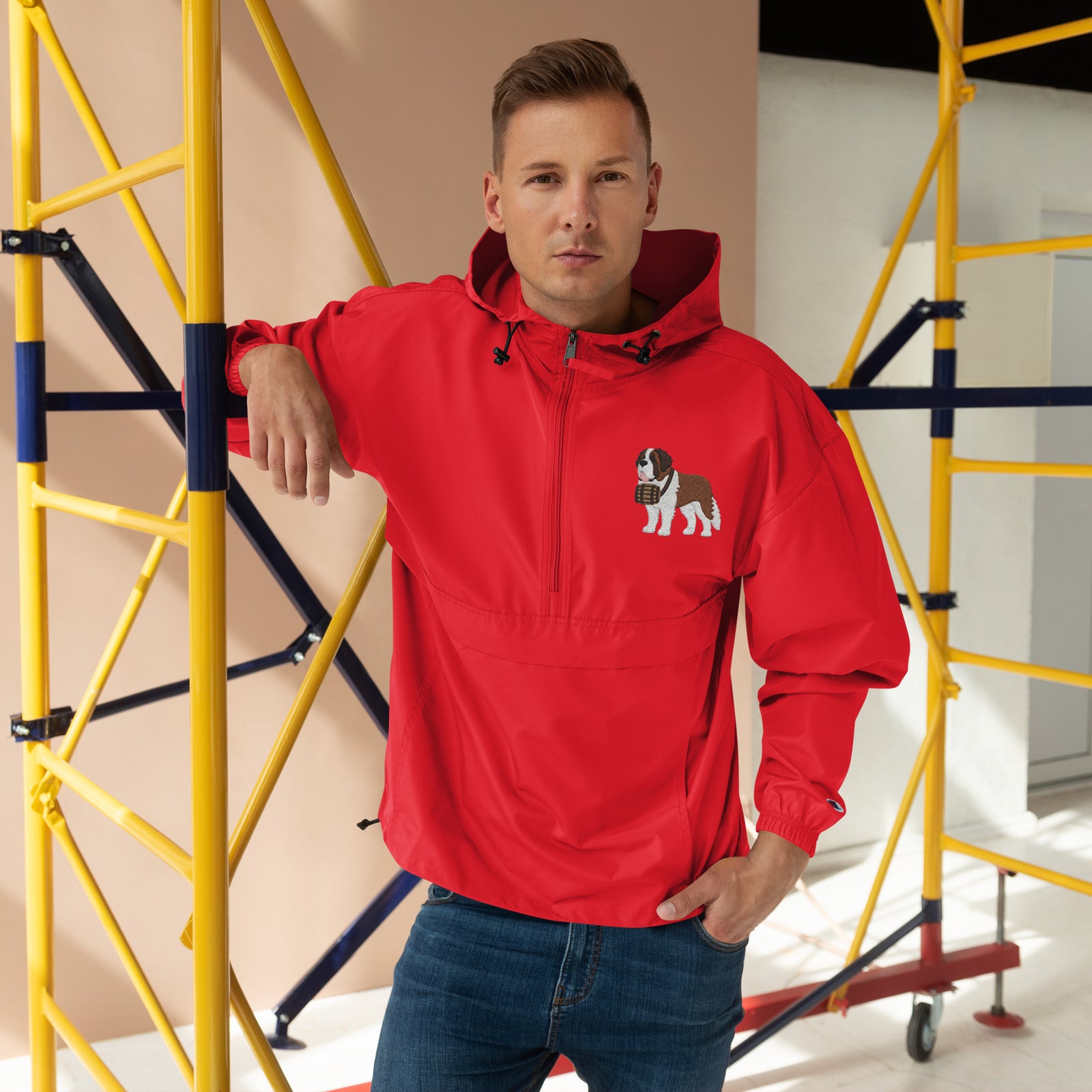 Red Champion packable windbreaker with chest embroidered Saint Bernard and barrel, half zip pullover with hood, kangaroo pocket, and zip pouch.