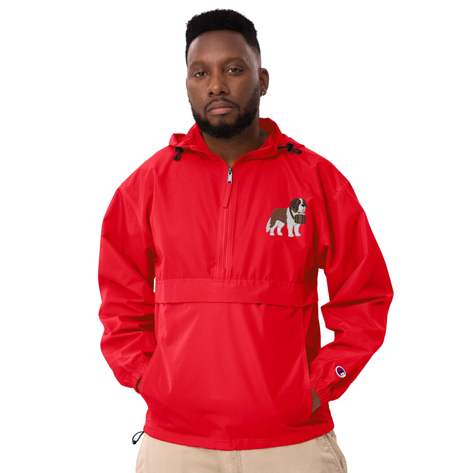 Red Champion packable windbreaker with chest embroidered Saint Bernard and barrel, half zip pullover with hood, kangaroo pocket, and zip pouch.
