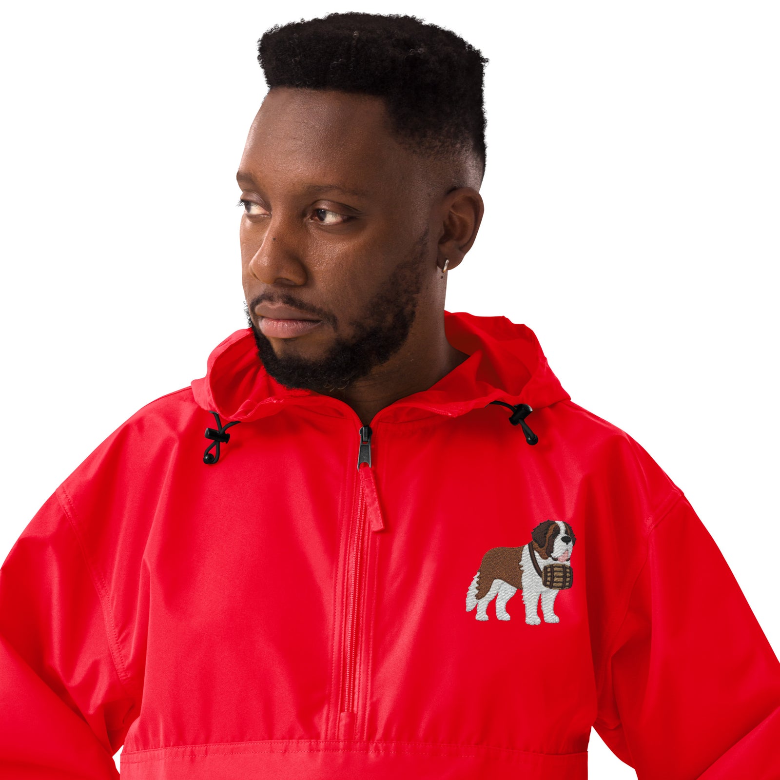 Red Champion packable windbreaker with chest embroidered Saint Bernard and barrel, half zip pullover with hood, kangaroo pocket, and zip pouch.