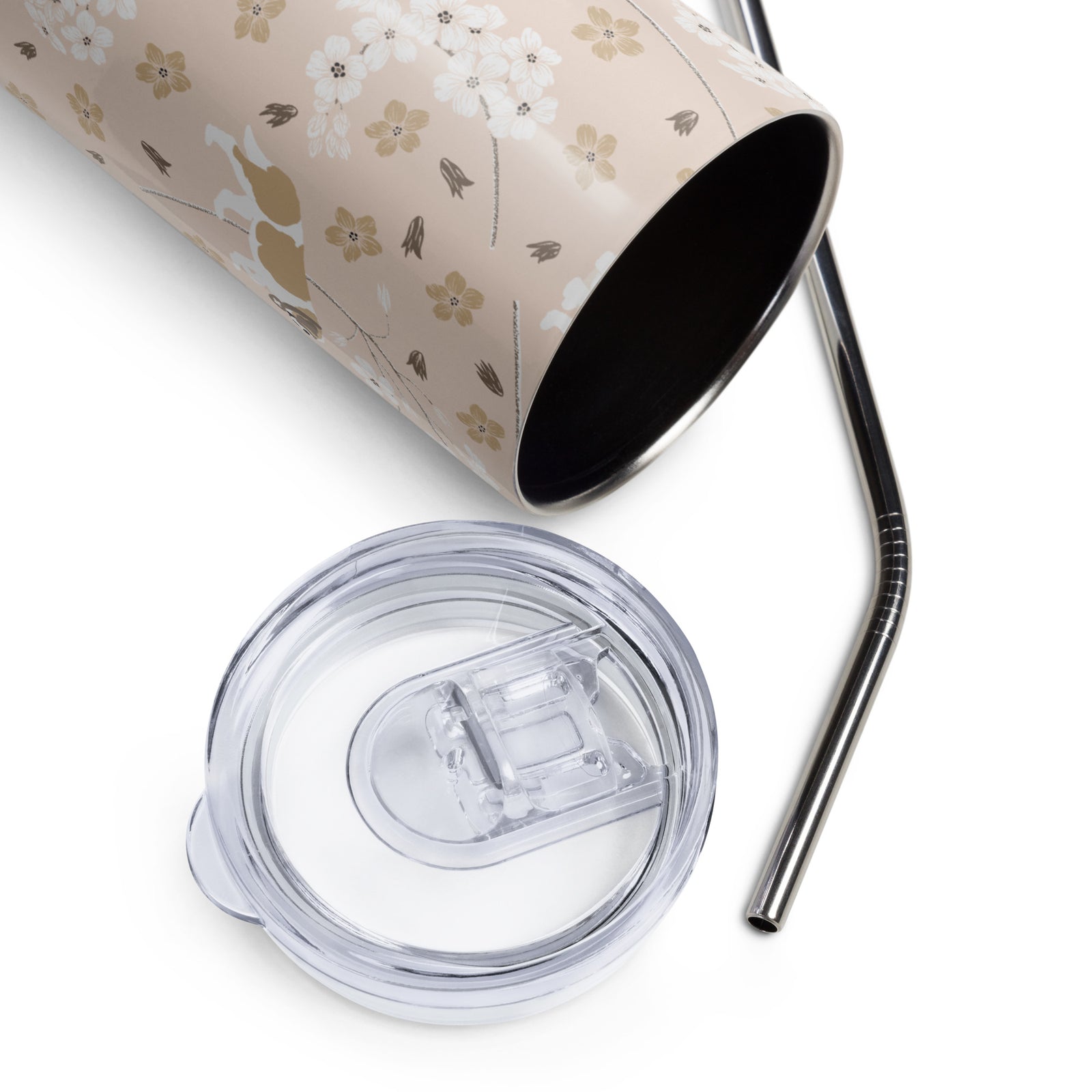 Stainless steel Forget Me Not Saint Bernard skinny tumbler with a blush finish featuring Saint Bernards among delicate white and golden florals, with a lid and metal straw.