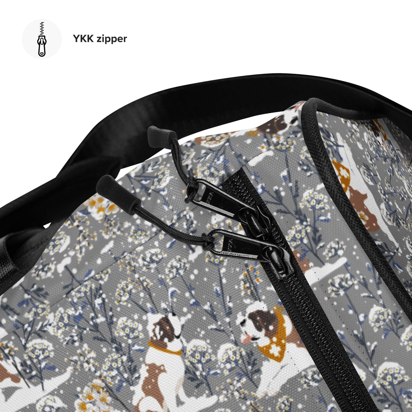Snowflowers Saint Bernard floral duffle bag in soft gray, blue, white, and winter floral tones with padded black shoulder strap, handles, zip compartment, and mesh side pocket.