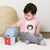 Child wearing a pink t-shirt with 'BIG DOG KID' and a Saint Bernard dog graphic on a white background.