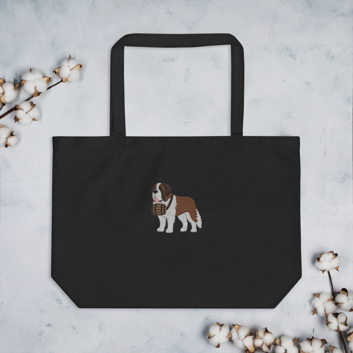 Large black organic tote bag embroidered with a detailed Saint Bernard with a barrel around its neck by Lucy and Norman.