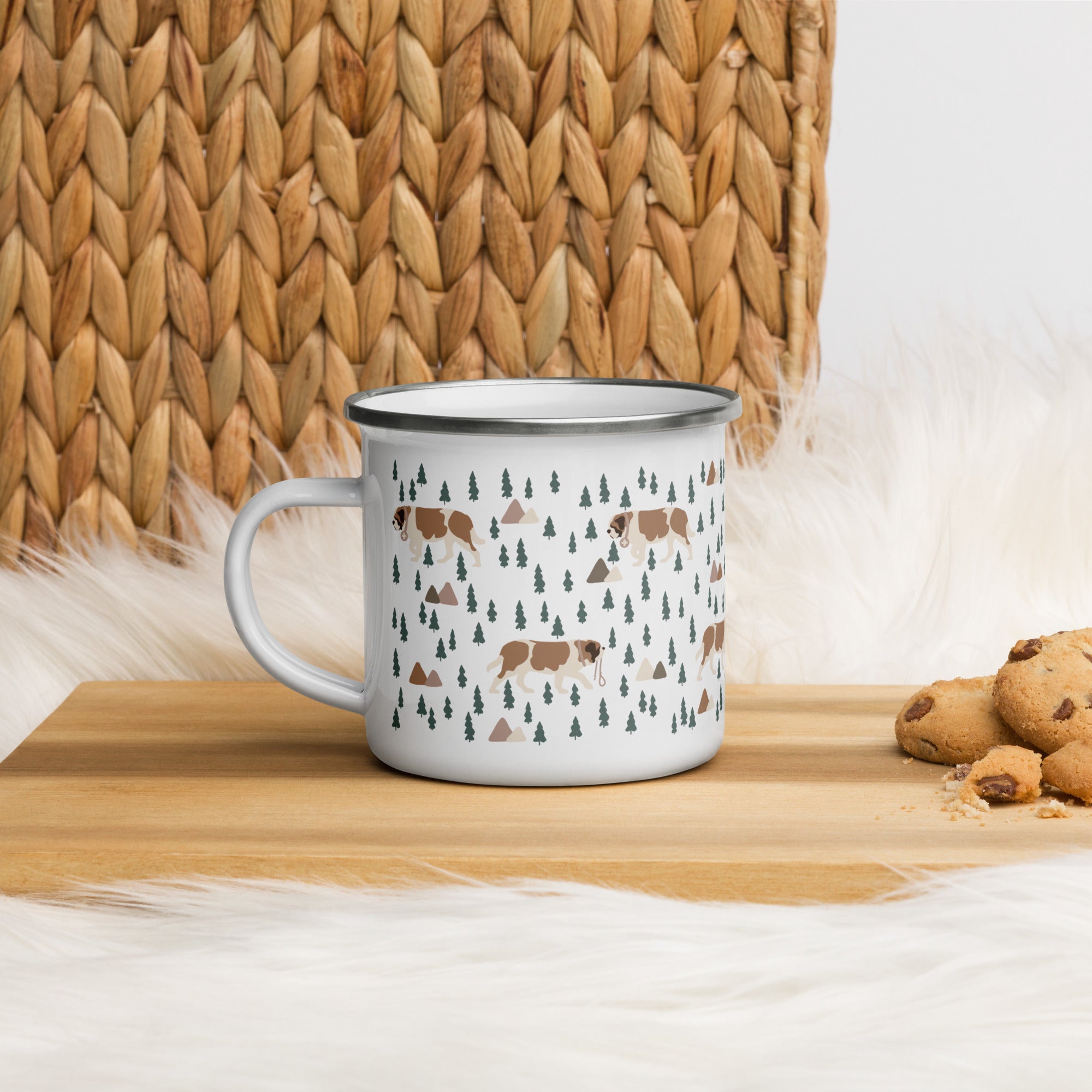Lightweight 12 oz enamel camp mug. Features a modern pattern of Saint Bernard dogs, mountains and pine trees on a white background by Lucy and Norman