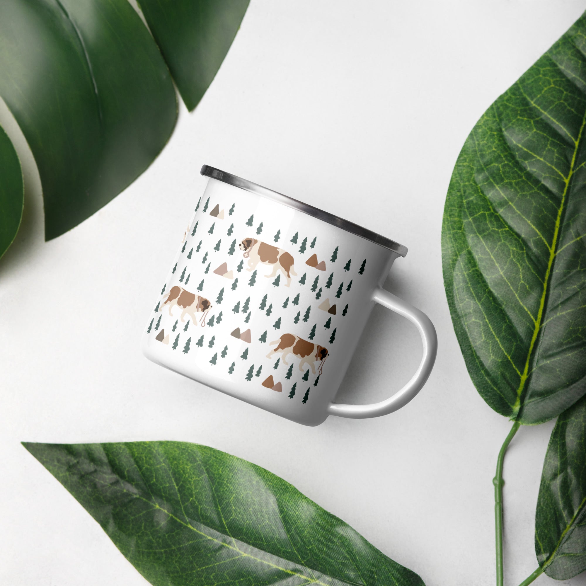 Lightweight 12 oz enamel camp mug. Features a modern pattern of Saint Bernard dogs, mountains and pine trees on a white background by Lucy and Norman