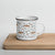Lightweight 12 oz enamel camp mug. Features a modern pattern of Saint Bernard dogs, mountains and pine trees on a white background by Lucy and Norman