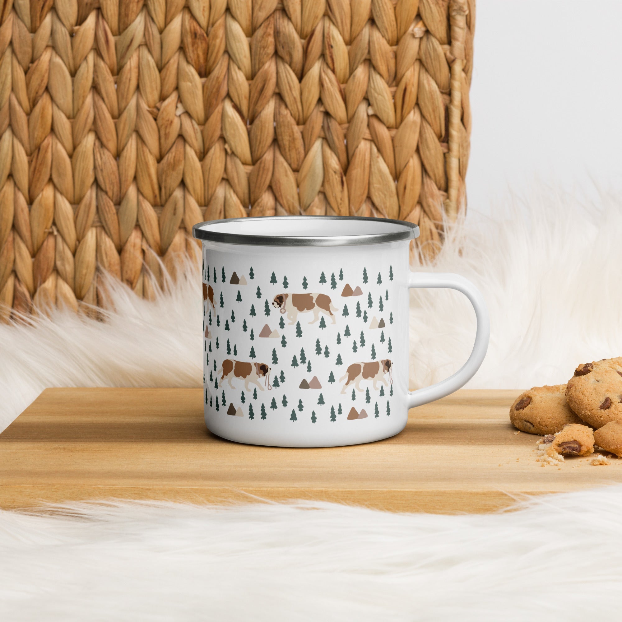 Lightweight 12 oz enamel camp mug. Features a modern pattern of Saint Bernard dogs, mountains and pine trees on a white background by Lucy and Norman