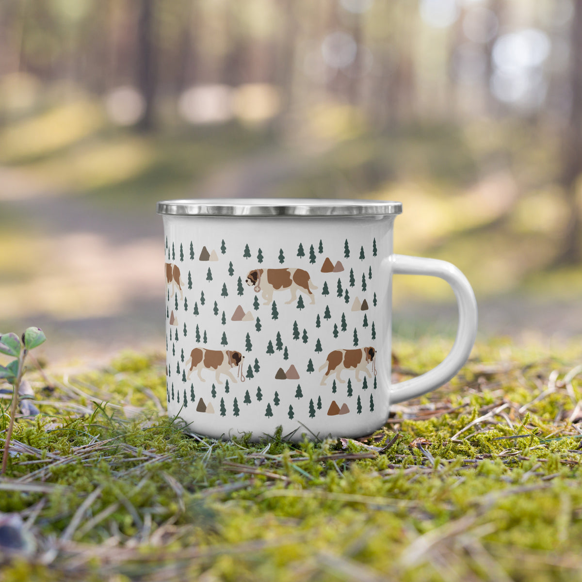 Lightweight 12 oz enamel camp mug. Features a modern pattern of Saint Bernard dogs, mountains and pine trees on a white background by Lucy and Norman