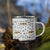 Lightweight 12 oz enamel camp mug. Features a modern pattern of Saint Bernard dogs, mountains and pine trees on a white background by Lucy and Norman