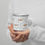 Lightweight 12 oz enamel camp mug. Features a modern pattern of Saint Bernard dogs, mountains and pine trees on a white background by Lucy and Norman
