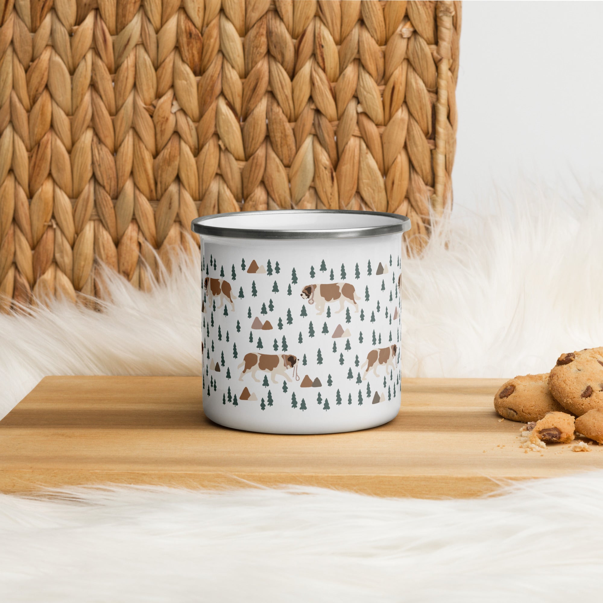 Lightweight 12 oz enamel camp mug. Features a modern pattern of Saint Bernard dogs, mountains and pine trees on a white background by Lucy and Norman