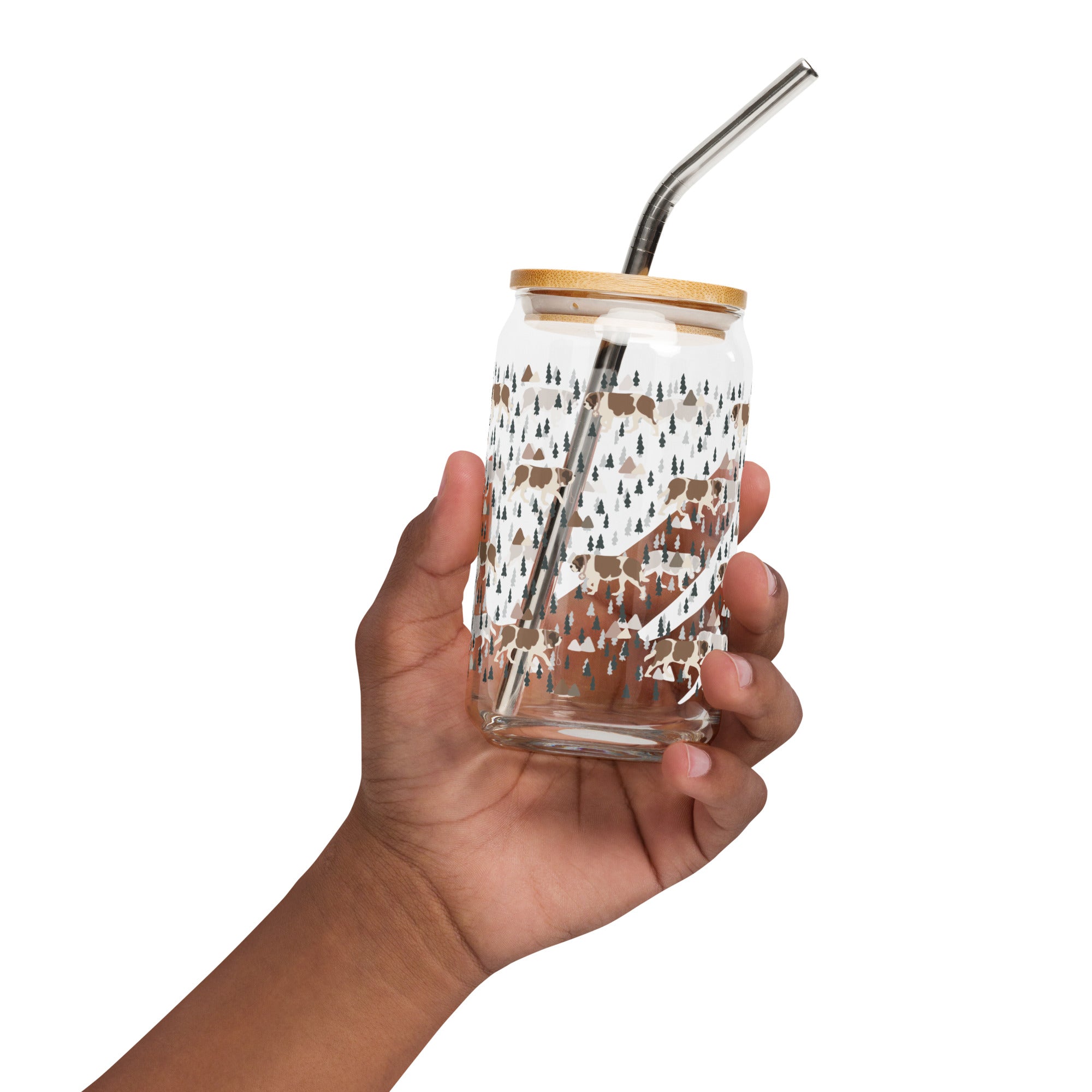 16 oz can-shaped glass tumbler, bamboo wood lid and metal straw. Features a modern pattern of Saint Bernard dogs, mountains and pine trees by Lucy and Norman