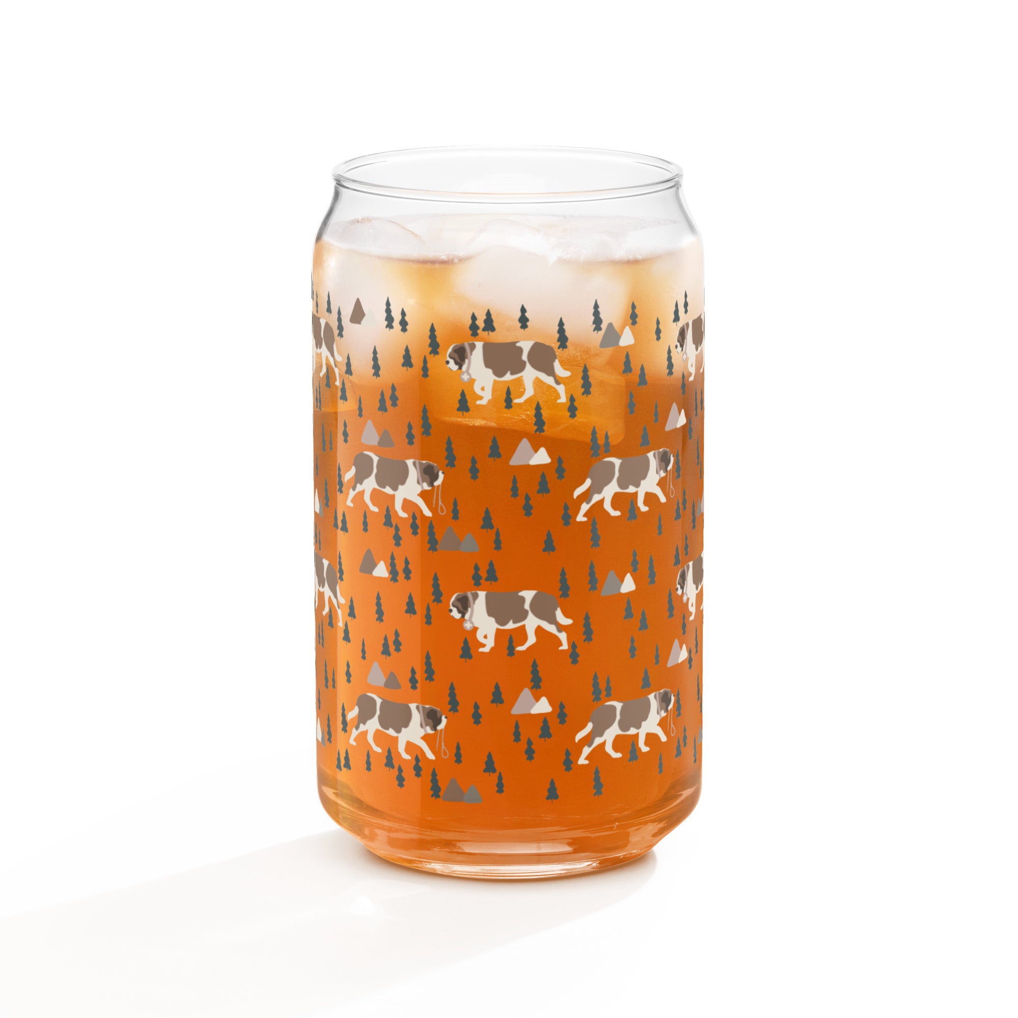 16 oz can-shaped glass tumbler. Features a modern pattern of Saint Bernard dogs, mountains and pine trees by Lucy and Norman