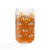 16 oz can-shaped glass tumbler. Features a modern pattern of Saint Bernard dogs, mountains and pine trees by Lucy and Norman