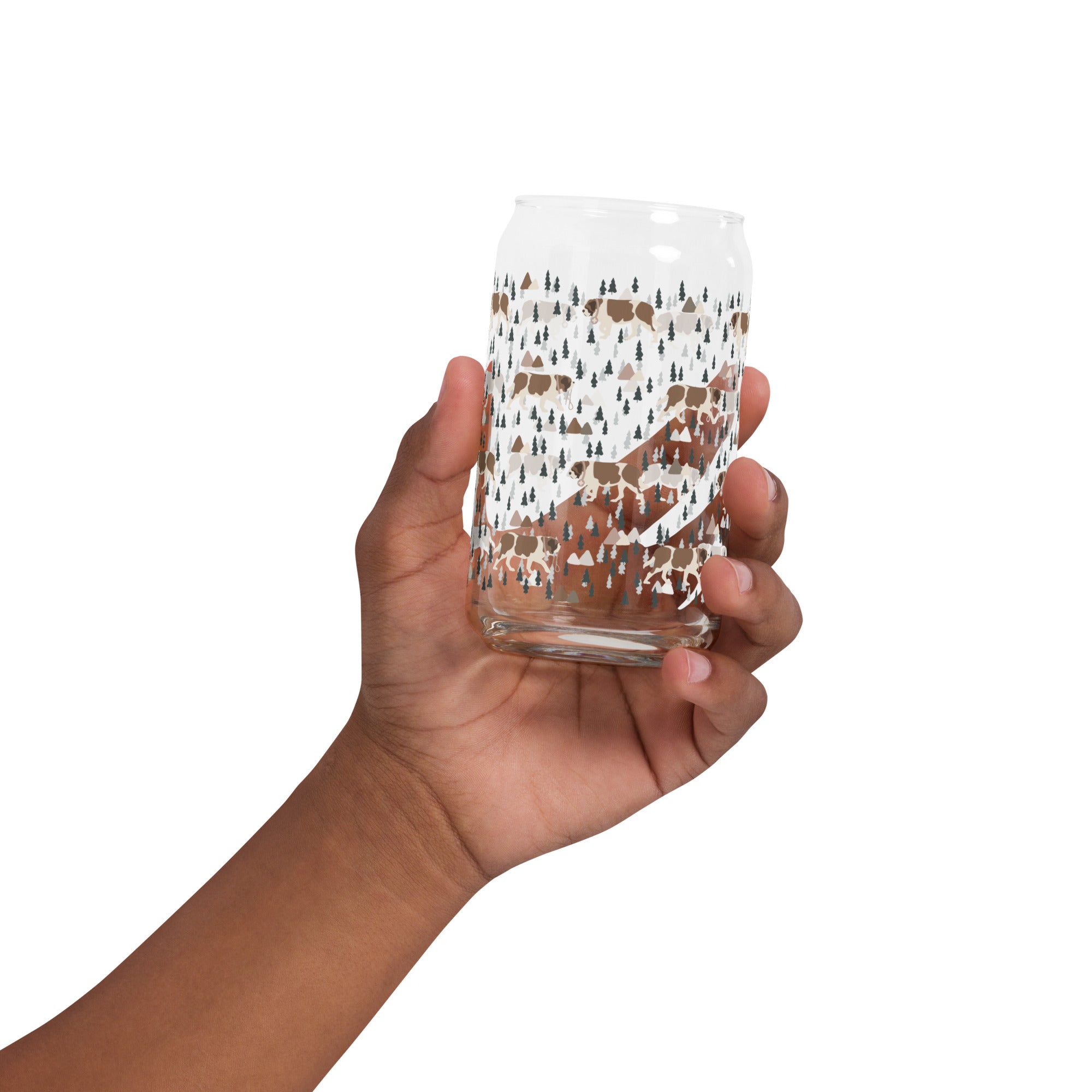 16 oz can-shaped glass tumbler. Features a modern pattern of Saint Bernard dogs, mountains and pine trees by Lucy and Norman