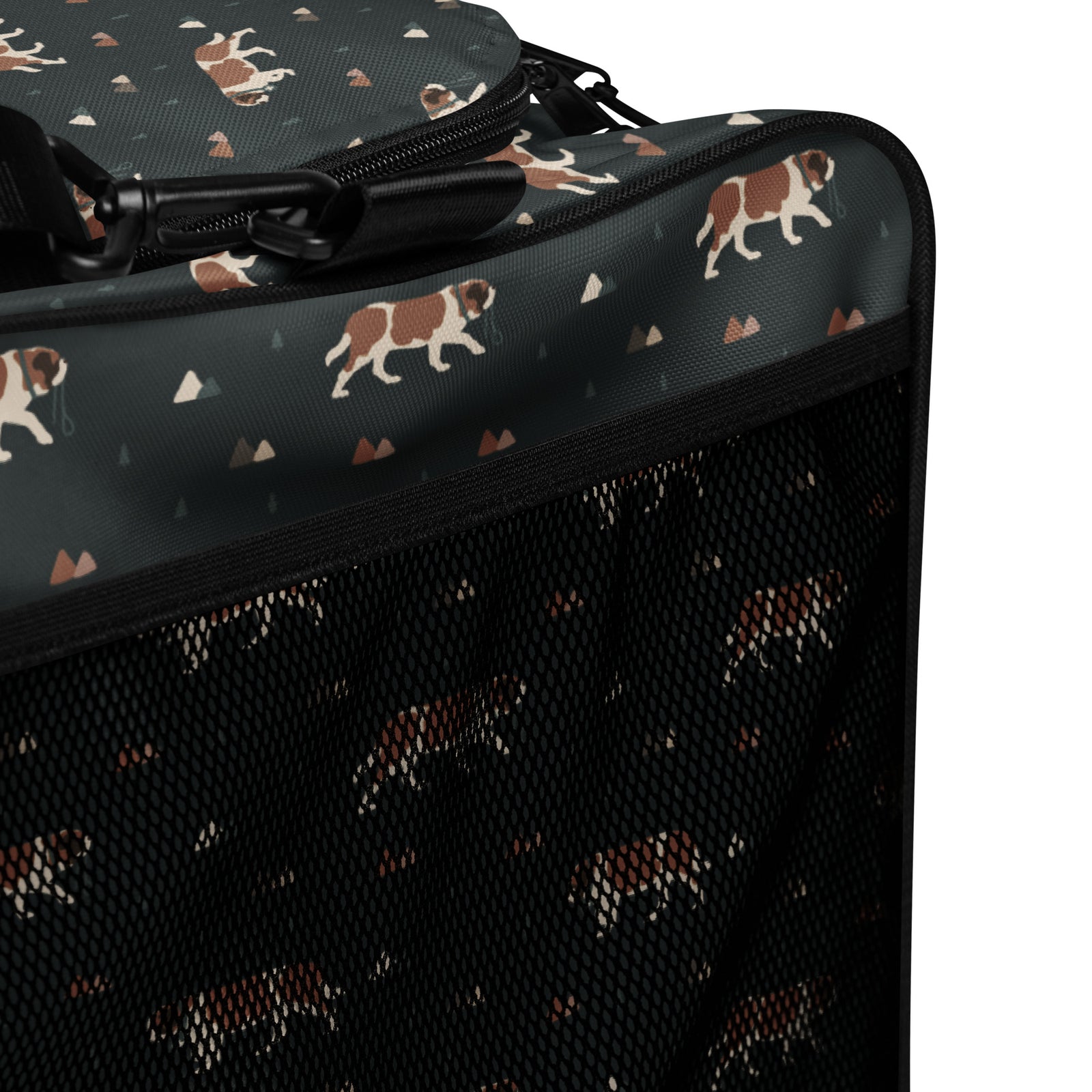 Green Mountain Saint Bernard duffle bag with adjustable padded black shoulder strap, handles, zip compartment, and mesh side pocket on dark green background with mountains, pines and dog pattern.