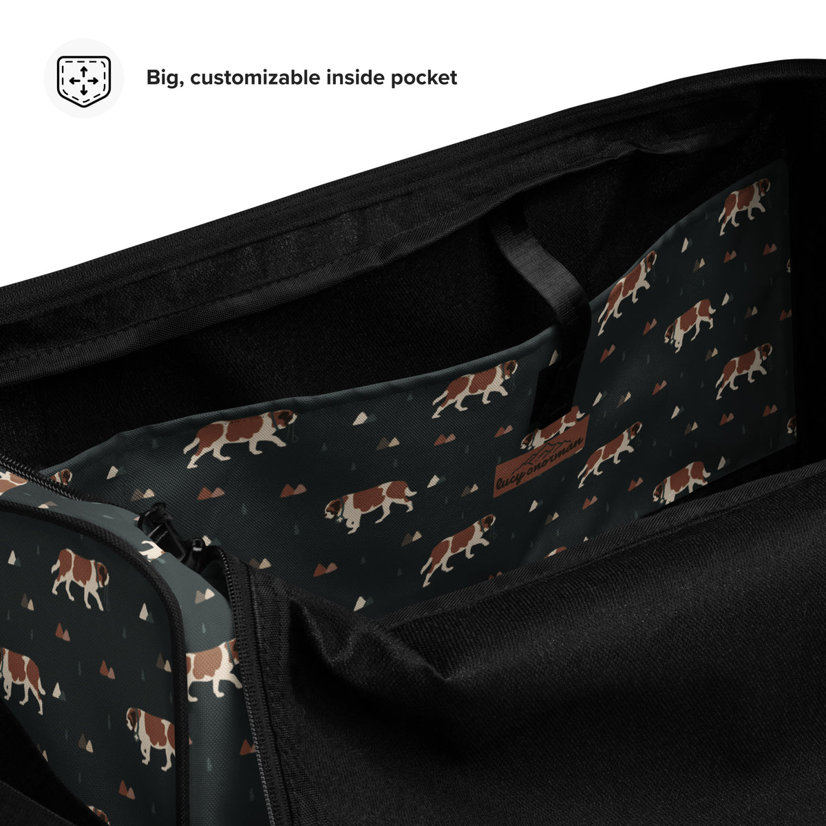 Green Mountain Saint Bernard duffle bag with adjustable padded black shoulder strap, handles, zip compartment, and mesh side pocket on dark green background with mountains, pines and dog pattern.
