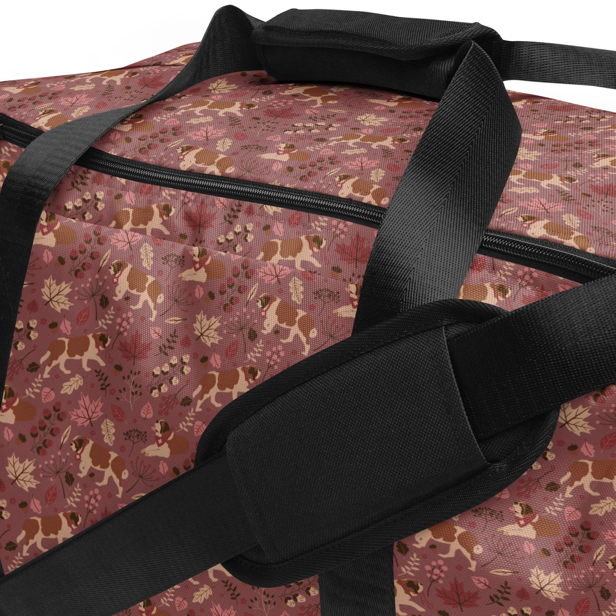 Rosy Fall Saint Bernard floral duffle bag in warm pink, brown, and autumn leaf tones with black padded shoulder strap, handles, zip compartment, and mesh side pocket.