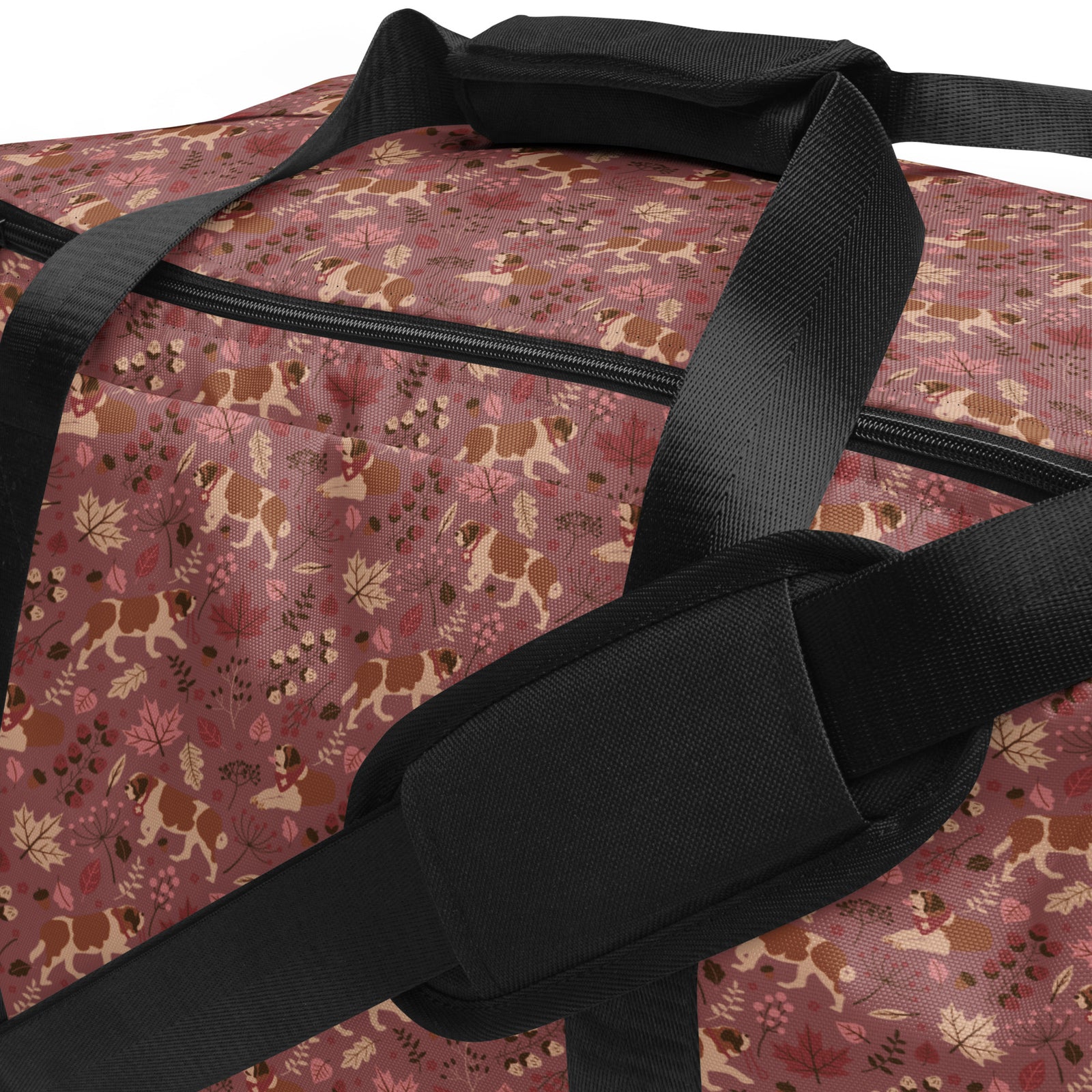 Rosy Fall Saint Bernard floral duffle bag in warm pink, brown, and autumn leaf tones with black padded shoulder strap, handles, zip compartment, and mesh side pocket.