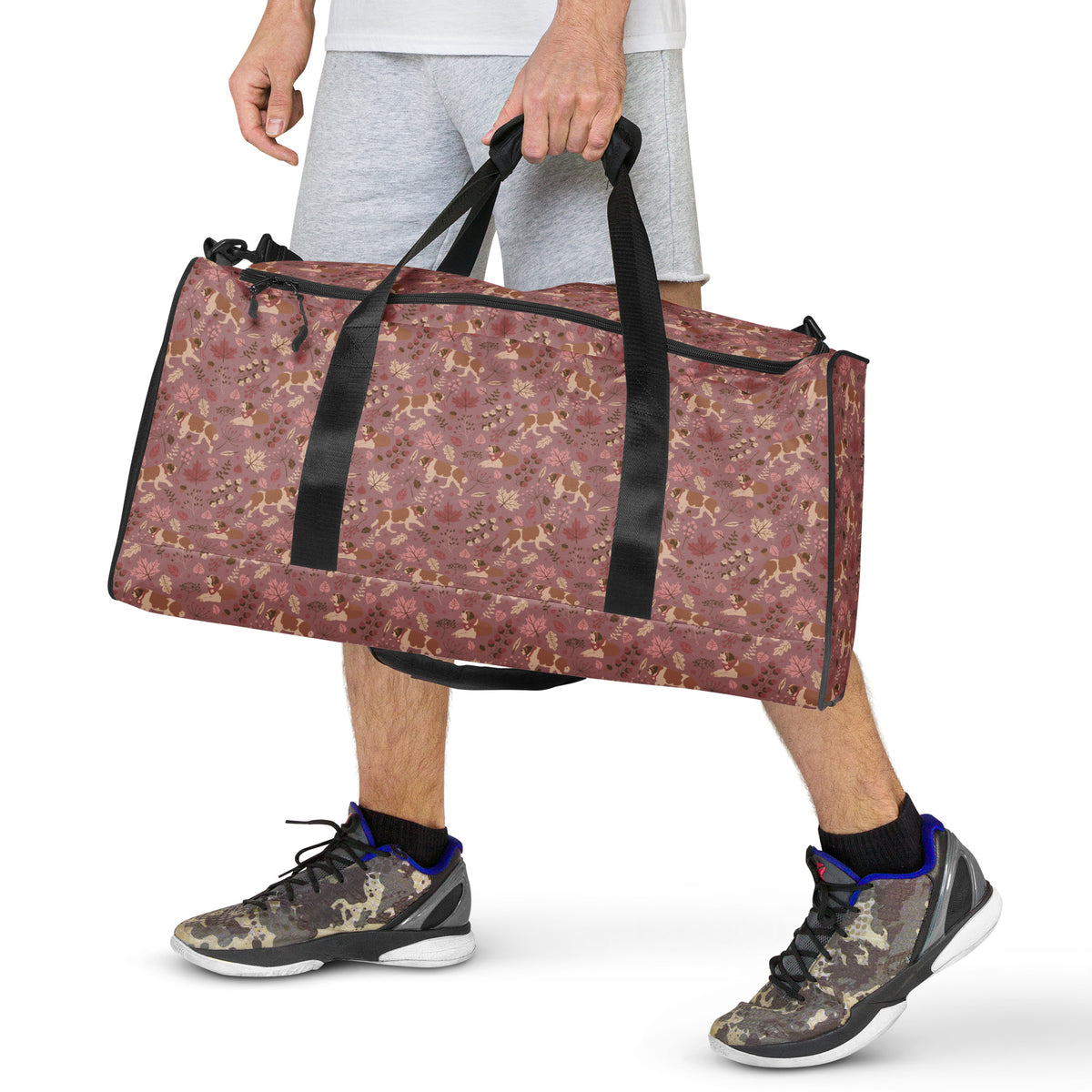 Rosy Fall Saint Bernard floral duffle bag in warm pink, brown, and autumn leaf tones with black padded shoulder strap, handles, zip compartment, and mesh side pocket.