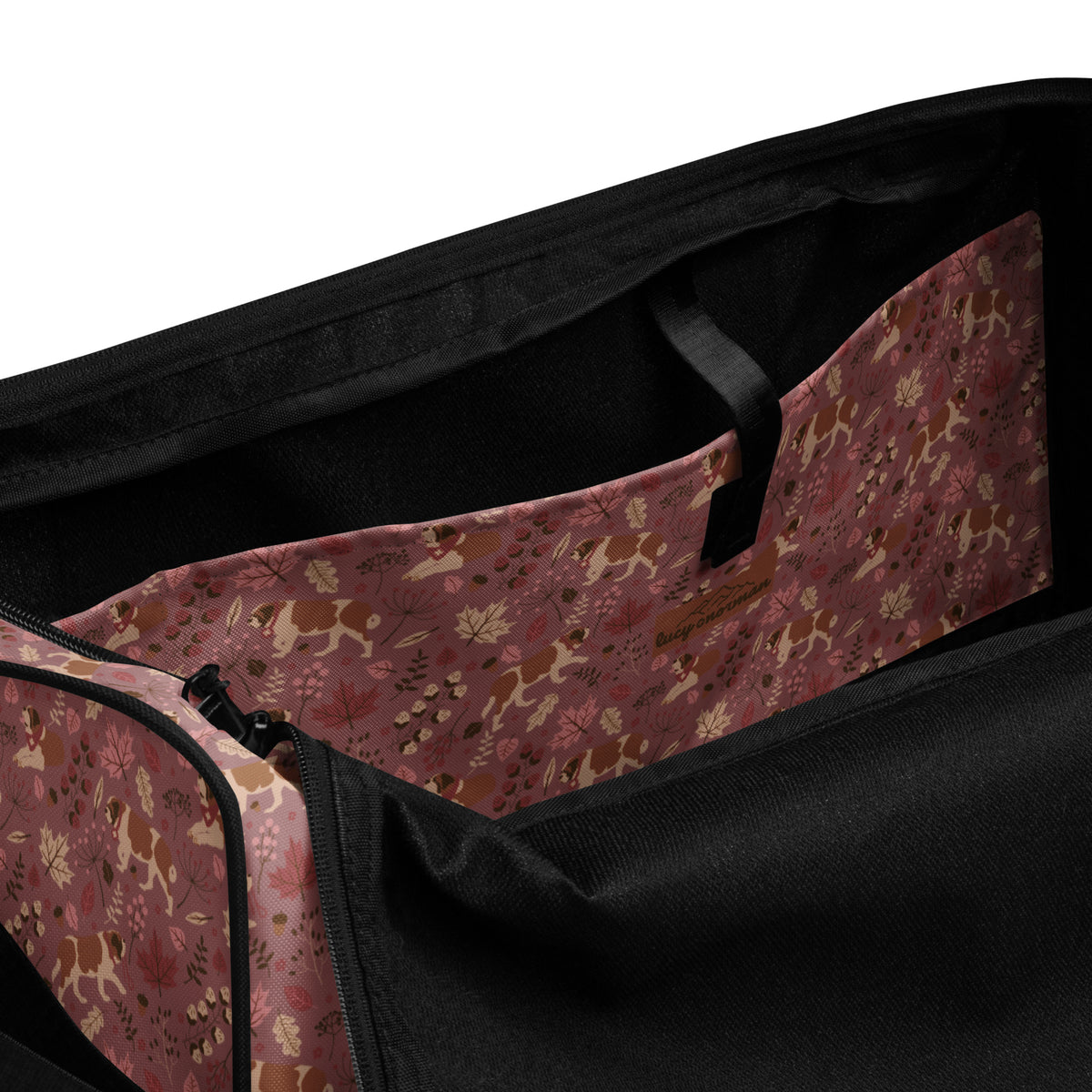 Rosy Fall Saint Bernard floral duffle bag in warm pink, brown, and autumn leaf tones with black padded shoulder strap, handles, zip compartment, and mesh side pocket.