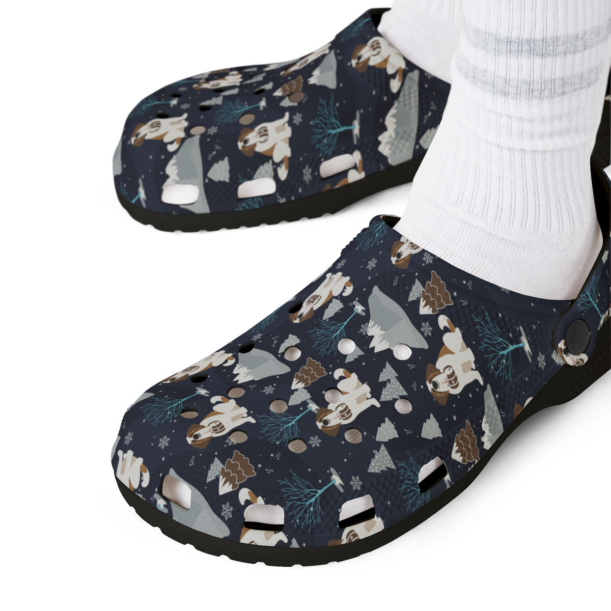 Black EVA clog shoes with a navy all-over alpine chill pattern featuring frosted mountain peaks, blue trees and Saint Bernards by Lucy and Norman