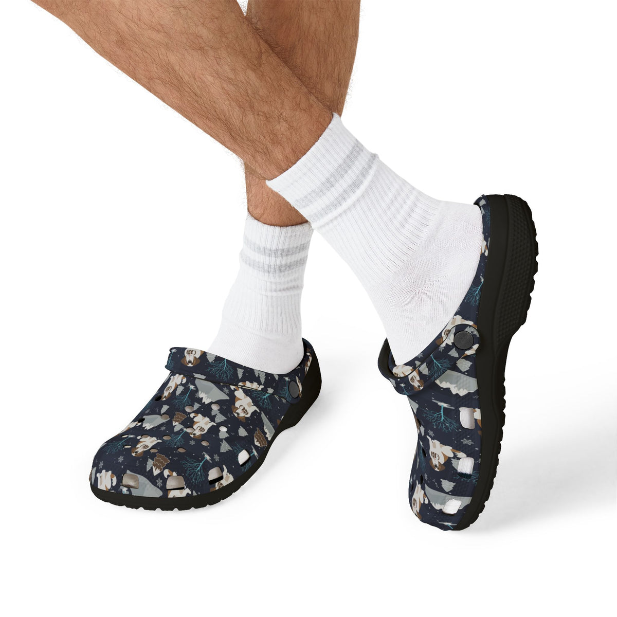 Black EVA clog shoes with a navy all-over alpine chill pattern featuring frosted mountain peaks, blue trees and Saint Bernards by Lucy and Norman